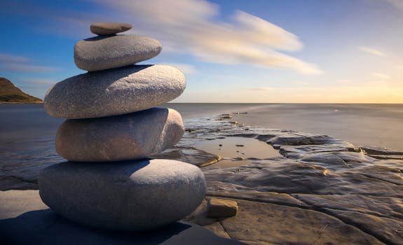pexels photo 289586 289586 A serene stack of stones on the rocky seashore during a peaceful sunrise, embodying balance and zen.